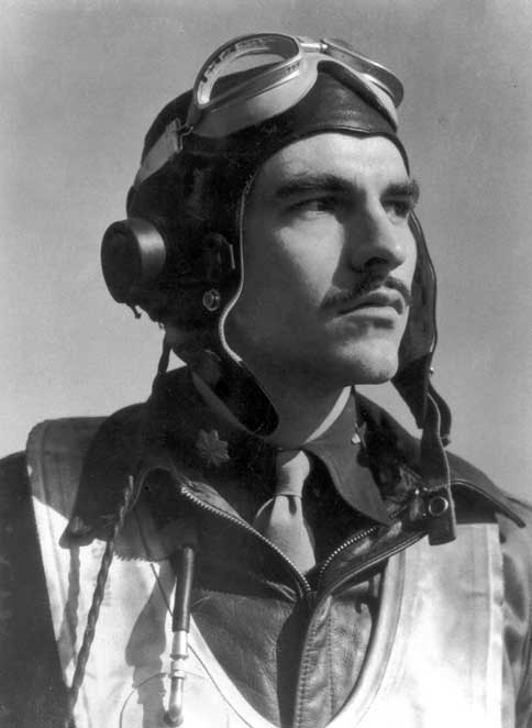 Pilot in vintage gear gazes upward, wearing leather helmet, goggles, and jacket. The image conveys a sense of determination and focus.